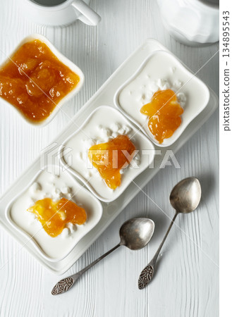 Cottage cheese with cream and yellow jam. Cottage cheese with cream and yellow jam. 134895543