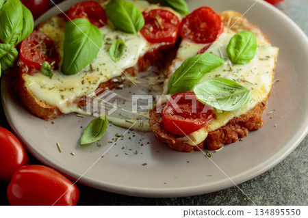 Hot open sandwiches with mozzarella, tomatoes and basil. Hot open sandwiches with mozzarella, tomatoes and basil. 134895550