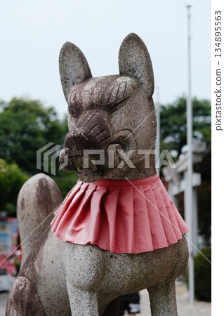 Stone Lion Guardian With Red Sash Stone Lion Guardian With Red Sash 134895563