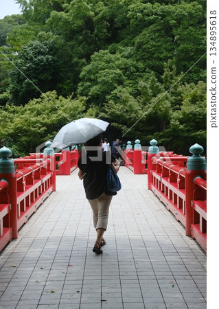 Lone Walker Crossing Red Bridge Pathway Lone Walker Crossing Red Bridge Pathway 134895618