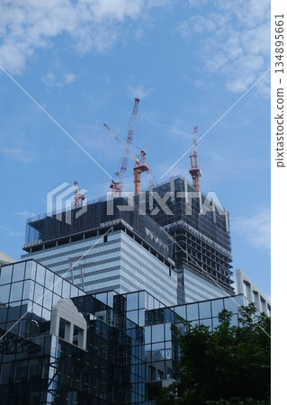 Modern Skyscraper Construction Rising Towards Blue Sky 134895661