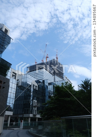 Modern Skyscraper Construction With Blue Sky Modern Skyscraper Construction With Blue Sky 134895667
