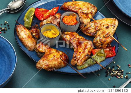 Grilled chicken wings kebab skewers and roasted vegetables Grilled chicken wings kebab skewers and roasted vegetables 134896180