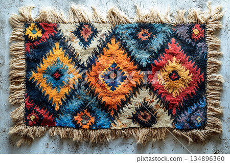 Handwoven rug texture with geometric print on a white background. Top view. Handwoven rug texture with geometric print on a white background. Top view. 134896360