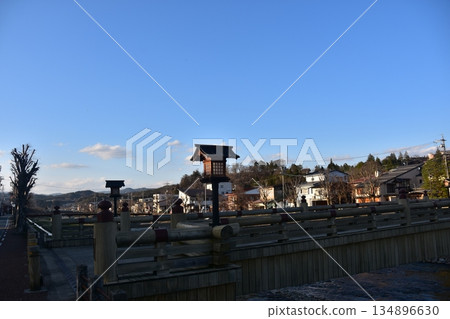 Takayama City, Gifu Prefecture, during the Spring Takayama Festival. Miyamae Bridge leading to the large torii gate of Sakurayama Hachiman Shrine. The Miyagawa River flowing through the city and the surrounding streets. 134896630