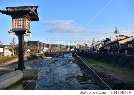Takayama City, Gifu Prefecture, Japan - During the Takayama Spring Festival, the Miyagawa River flowing through the city and the surrounding streets, retro Japanese-style streetlights on the bridge 134896709