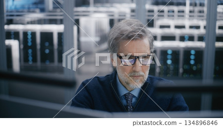 Focused, Male Manager Carefully Monitoring Data Systems 134896846