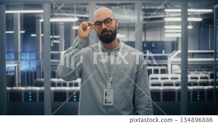 Technical Expert With Warm, Professional Expression in Data Center Control Room Technical Expert With Warm, Professional Expression in Data Center Control Room 134896886