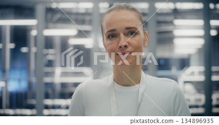 Confident Woman Working in Clean, Structured Environment of Secure Data Facility Confident Woman Working in Clean, Structured Environment of Secure Data Facility 134896935