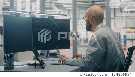 Bearded Male Engineer Programming or Developing Digital Twin Bearded Male Engineer Programming or Developing Digital Twin 134896954