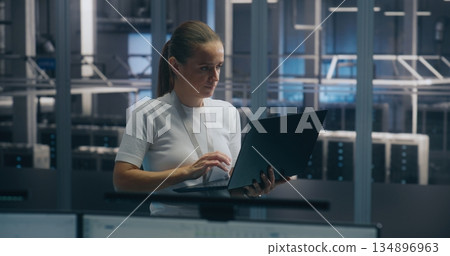Experienced Female Engineer Uses Portable PC Run Diagnostics Performance Metrics Experienced Female Engineer Uses Portable PC Run Diagnostics Performance Metrics 134896963