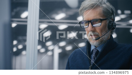 Professional in Call Center Setup, Answering Critical Technical Issues With Headset in Server Hall Professional in Call Center Setup, Answering Critical Technical Issues With Headset in Server Hall 134896975