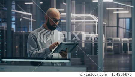 On Site Coordination, IT Specialist Using Tablet to Diagnose Rack Status On Site Coordination, IT Specialist Using Tablet to Diagnose Rack Status 134896976