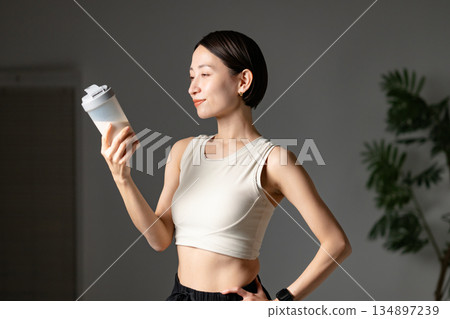Woman drinking protein Woman drinking protein 134897239