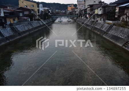 Takayama City, Gifu Prefecture, Japan - During the Takayama Spring Festival, the Miyagawa River flows through the city and the surrounding streets, with old Japanese houses and long-established inns 134897255