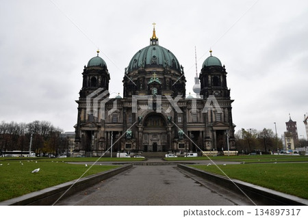 Berlin Cathedral, a historic building symbolizing the German capital, is a beautiful dome architecture that exudes majesty under a cloudy sky. Berlin Cathedral, a historic building symbolizing the German capital, is a beautiful dome architecture that exudes majesty under a cloudy sky. 134897317
