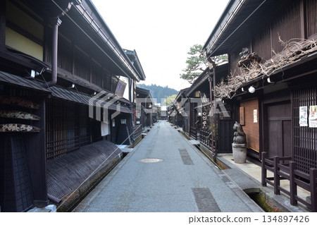 Old townscape of Takayama City, Gifu Prefecture, Japan. Old houses exuding a sense of history. Morning scene during the Takayama Spring Festival. Old townscape of Takayama City, Gifu Prefecture, Japan. Old houses exuding a sense of history. Morning scene during the Takayama Spring Festival. 134897426