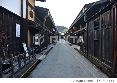 Old townscape of Takayama City, Gifu Prefecture, Japan. Old houses exuding a sense of history. Morning scene during the Takayama Spring Festival. 134897435