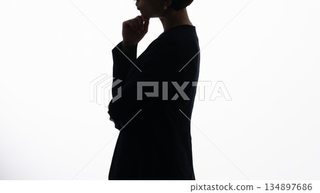 Silhouette of a worried woman 134897686