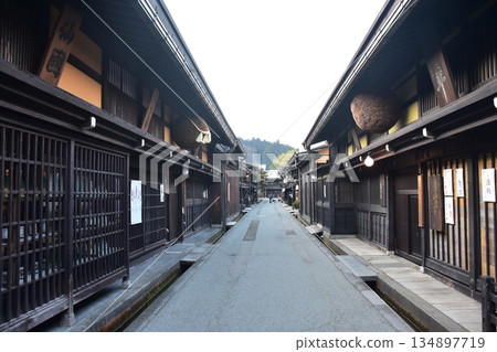Old townscape of Takayama City, Gifu Prefecture, Japan. A sake shop decorated with cedar balls and an old house with a sense of history. Morning scene during the Takayama Spring Festival. 134897719