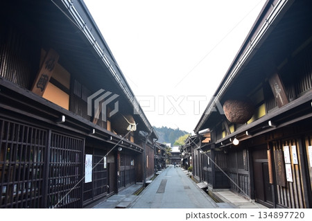 Old townscape of Takayama City, Gifu Prefecture, Japan. A sake shop decorated with cedar balls and an old house with a sense of history. Morning scene during the Takayama Spring Festival. 134897720