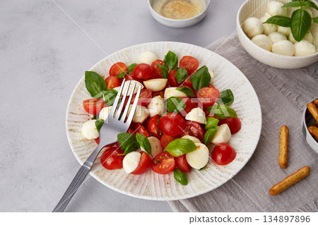Caprese salad with cherry tomatoes , mozzarella cheese, basil Caprese salad with cherry tomatoes , mozzarella cheese, basil 134897896