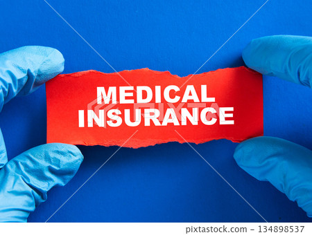 Hands in medical gloves holding a medical insurance concept 134898537