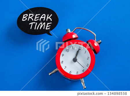 Red alarm clock showing break time concept Red alarm clock showing break time concept 134898538
