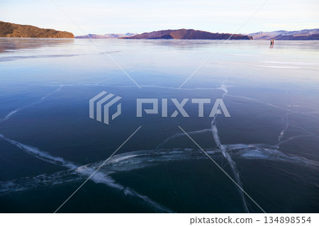 Frozen Lake Baikal on a sunny winter day. Frozen Lake Baikal on a sunny winter day. 134898554