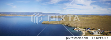 Lake Baikal on a sunny summer day. Panorama of the Olkhon Gate Strait. A ferry carries passengers to Olkhon Island. Lake Baikal on a sunny summer day. Panorama of the Olkhon Gate Strait. A ferry carries passengers to Olkhon Island. 134899014