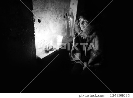Old woman hiding in bombshelter cellar Old woman hiding in bombshelter cellar 134899055