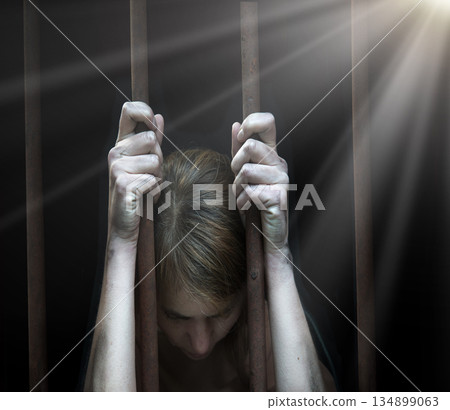 Sad young girl in prison 134899063