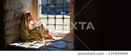 Lone girl sitting in the castle 134899068