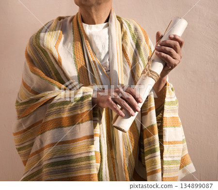 Male hand holding an old scroll 134899087