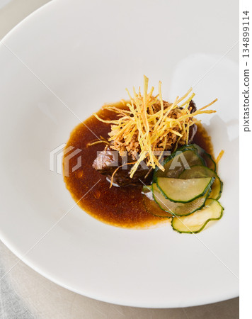 Sophisticated main course featuring tender beef and refined accompaniments 134899114