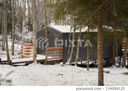 Secluded woodland cottage covered in snow offering peace Secluded woodland cottage covered in snow offering peace 134899125