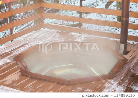 fogfilled jacuzzi releasing gentle steam on snowy deck fogfilled jacuzzi releasing gentle steam on snowy deck 134899130