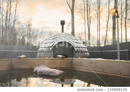 Relaxing natural hot spring experience in forest setting at sunrise Relaxing natural hot spring experience in forest setting at sunrise 134899139