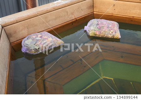 Peaceful hot bath surrounded by gentle steam and tranquil ambiance 134899144