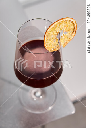Relaxed Afterhours Cocktail Atmosphere, Elegant Drink With Orange Garnish Under Soft Lighting Ambiance Relaxed Afterhours Cocktail Atmosphere, Elegant Drink With Orange Garnish Under Soft Lighting Ambiance 134899208