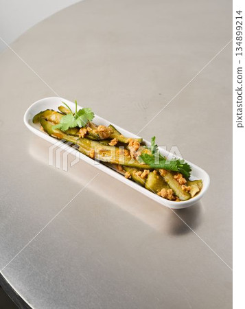 Elegant herb roasted potato ribbons served in modern setting with garnish Elegant herb roasted potato ribbons served in modern setting with garnish 134899214