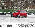 Automobile expertly executing controlled oversteer in winter conditions 134899220