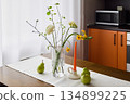 Wellorganized kitchen corner with floral decor and cozy lighting setup 134899225