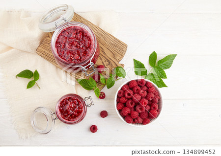 Homemade jam. Jars of raspberry jam and a bowl of fresh berries Homemade jam. Jars of raspberry jam and a bowl of fresh berries 134899452