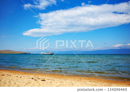 Lake Baikal on a sunny summer day. Olkhon Island. The ship transports tourists. 134899469
