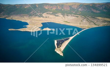 Lake Baikal from the air. View of the bay near the village of Kurma, Cape Uyuga. Lake Baikal from the air. View of the bay near the village of Kurma, Cape Uyuga. 134899521
