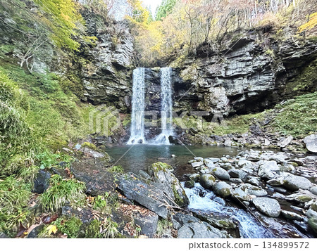 A waterfall surrounded by fresh greenery 134899572