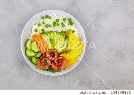 Poke bowl with salmon, rice, avocado, cucumber, mango, micro green Poke bowl with salmon, rice, avocado, cucumber, mango, micro green 134899586