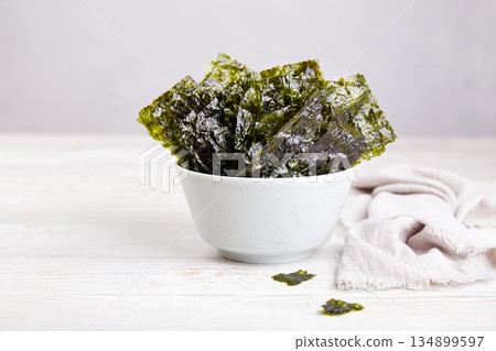 Crispy nori seaweed on bowl. Traditional Japanese dry seaweed sheets. Crispy nori seaweed on bowl. Traditional Japanese dry seaweed sheets. 134899597
