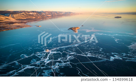 Aerial photography of Lake Baikal in winter. Frozen lake, transparent ice with cracks 134899618